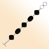 Handcrafted silver bracelet with alternating oval and cushion black shell links, elegant design.